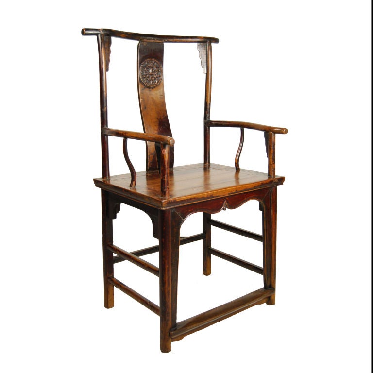 A 19th century Chinese elmwood administrator's chair with lotus carved back splat and beautiful patina.