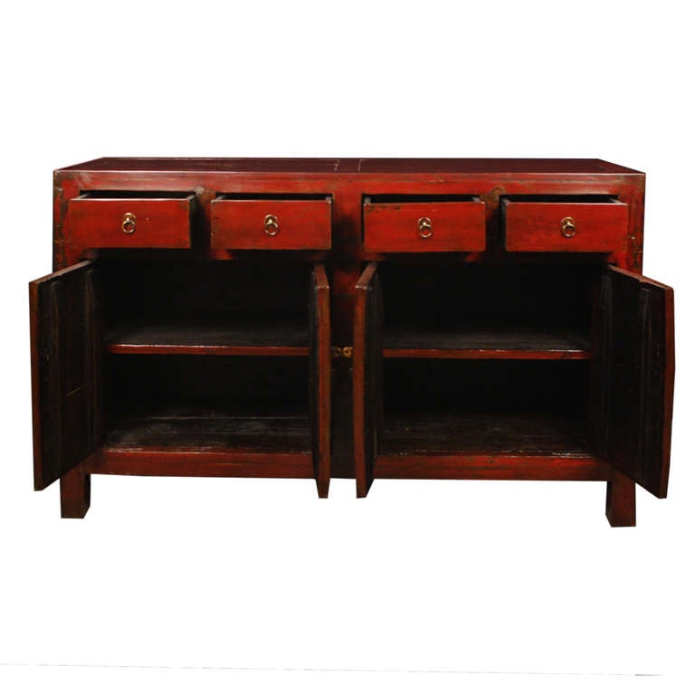 A red lacquer chest from Shanxi Province, China. This chest has four drawers atop four doors all with brass fixtures.