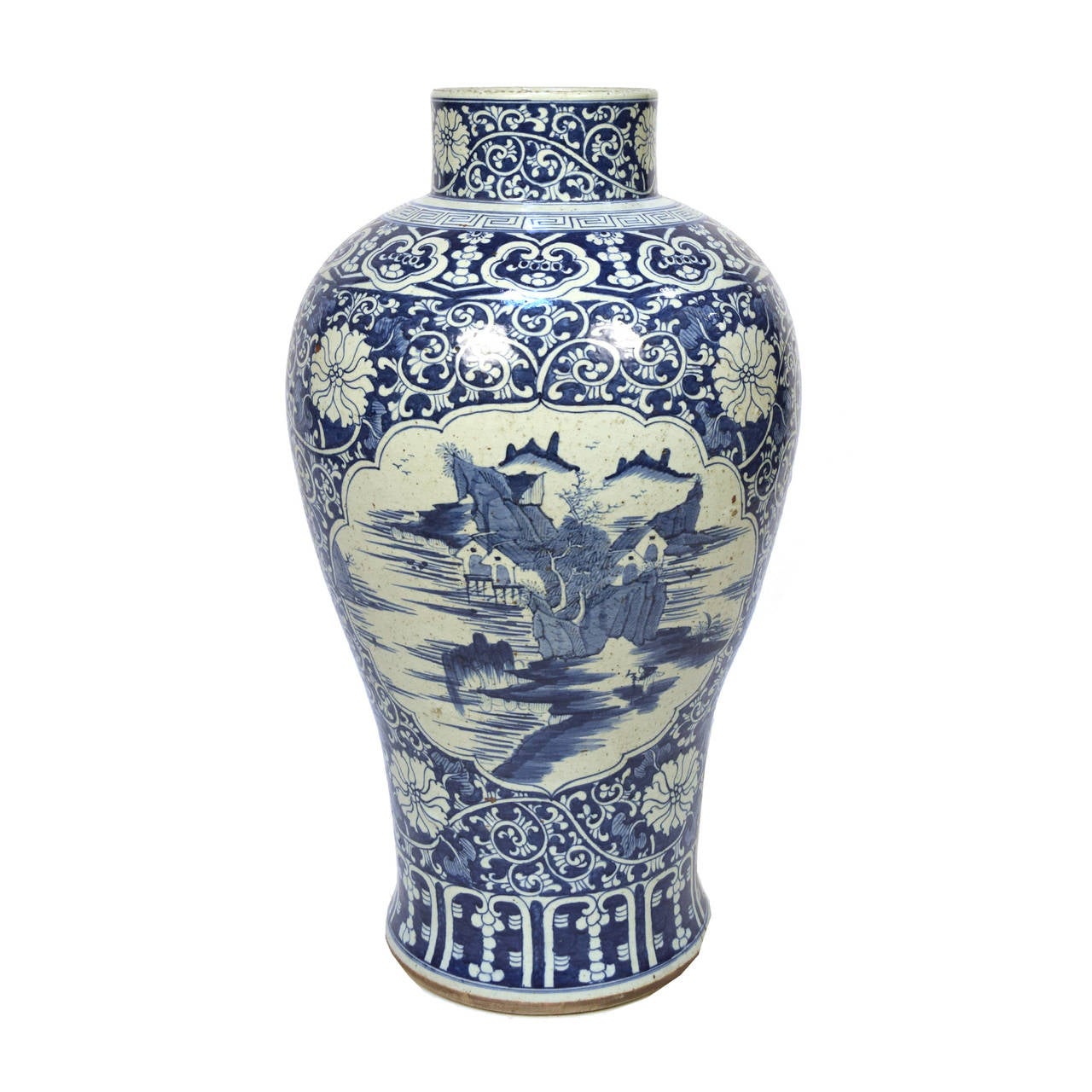 A pair of ceramic monumental blue and white vases from Beijing, China painted with a landscape scene surrounded by a floral vine motif.

          