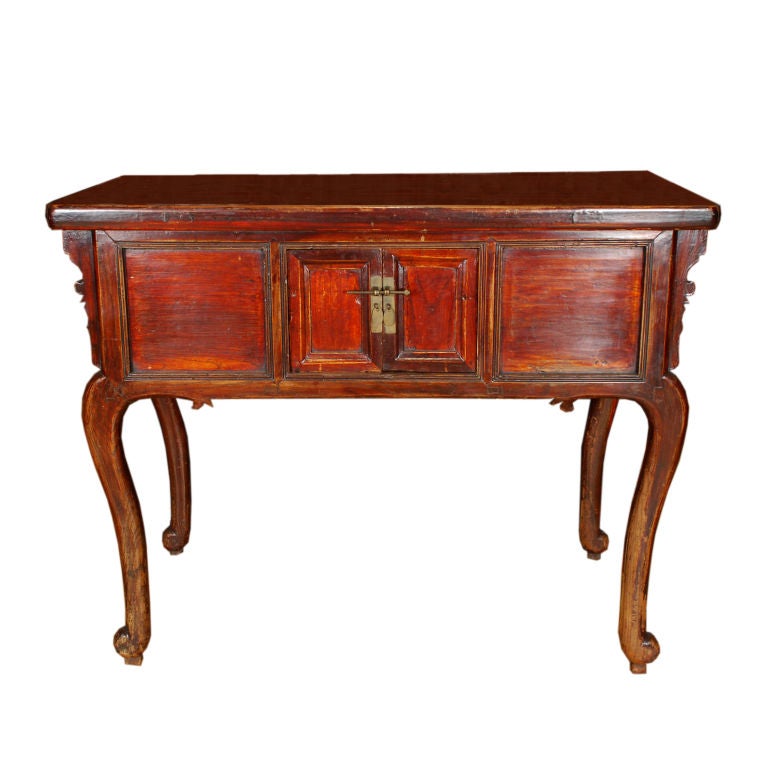 An early 20th century Chinese elmwood altar table with European inspired design, two doors and brass hardware. 