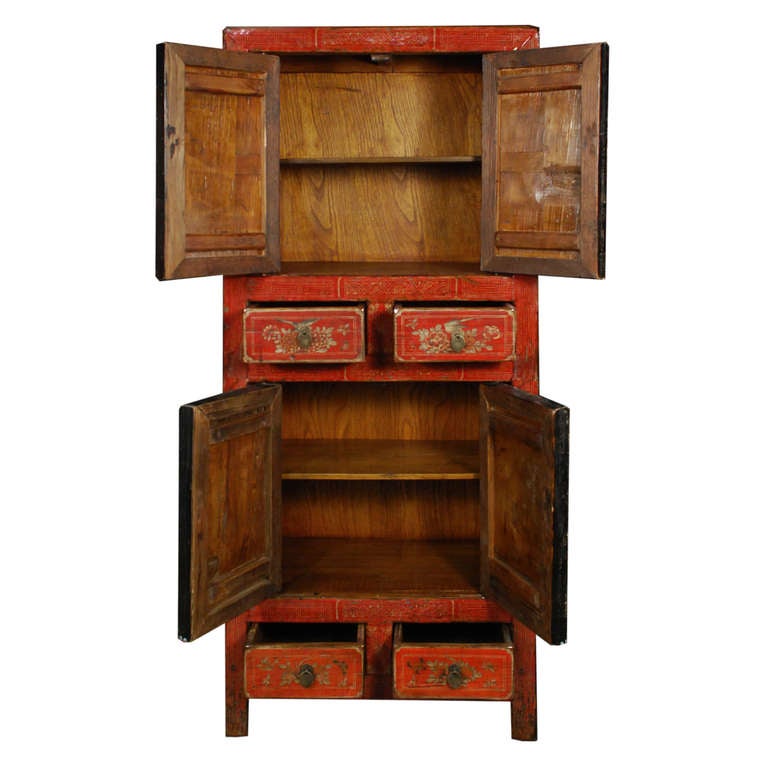 Red floral painted cabinet from Dongbei Province, China. This cabinet features four doors and four drawers for lots of storage potential.