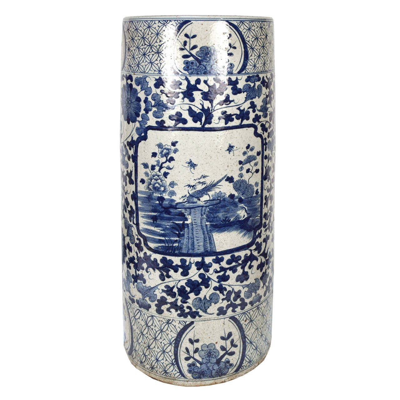 A pair of Chinese tall cylindrical blue and white ceramic containers painted painted with birds, flowers, and vines.