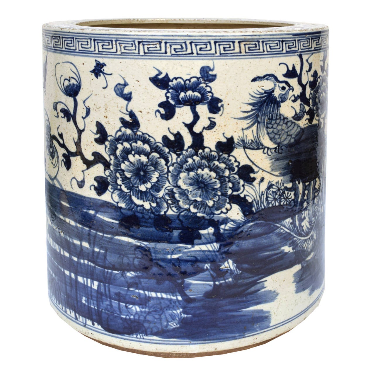 A blue and white water pot from Northern China painted with a scene of phoenix amongst flowers and vines.

        