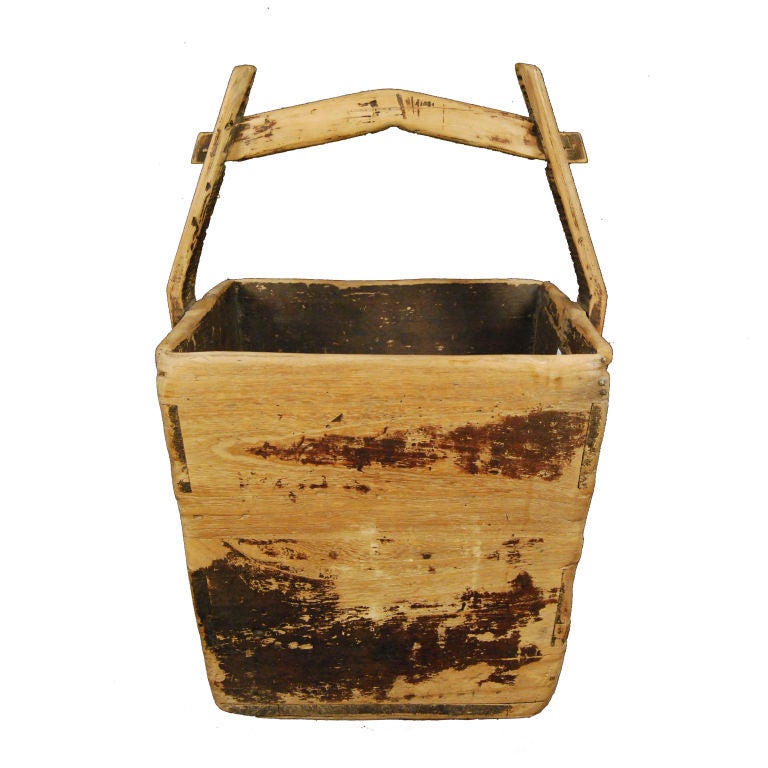 A 19th century Chinese grain bucket with handle and well worn surface.<br />
<br />
Pagoda Red Collection #:  Z202B<br />
<br />
<br />
Keywords:  Bucket, basket, box, vessel, vase, bowl, conatiner