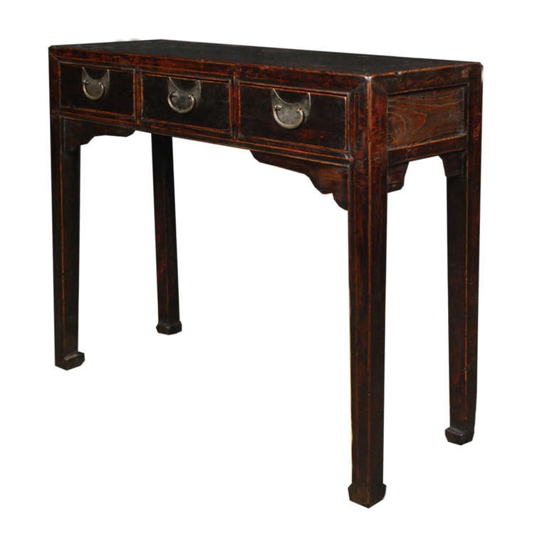 A beautiful altar table from Henan Province, China. This circa 1850 table is made of Elmwood and Rosewood and features three drawers with half moon shaped hardware.

Pagoda Red Collection # BJC126