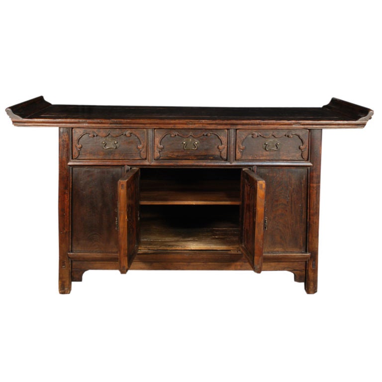 A 19th century Chinese elmwood coffer with everted ends, three drawers, two doors and brass hardware.

Pagoda Red Collection #:  Z193

Keywords:  Console table, sofa table, sideboard, buffet, server, credenza, dresser, media
