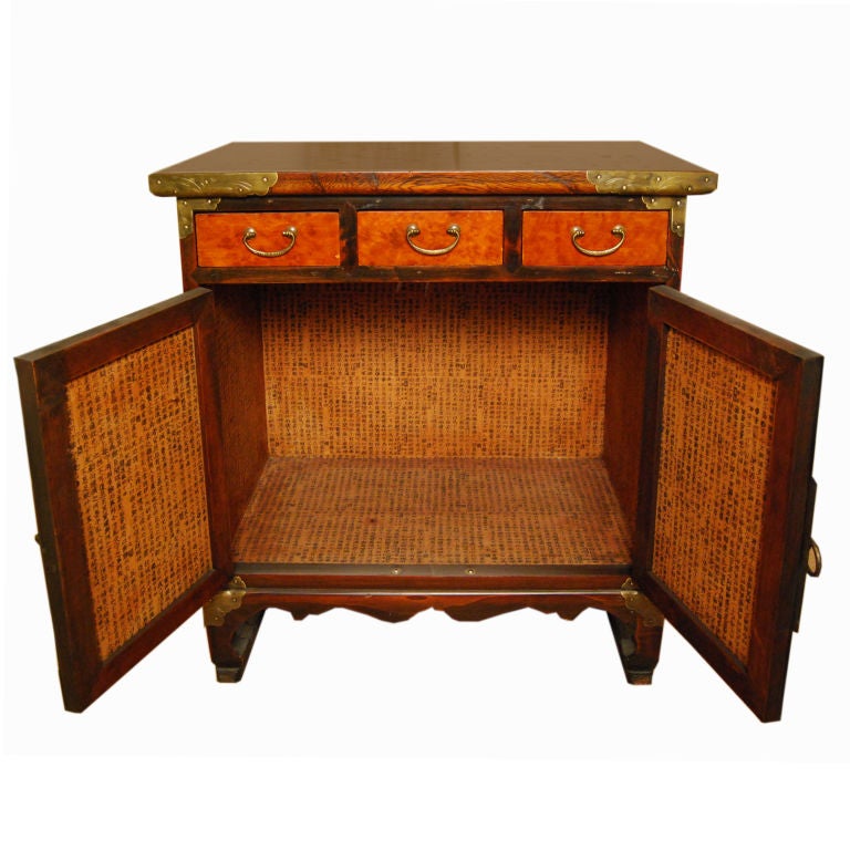 An early 20th century Korean paulownia and elmwood chest with elaborate brass mounts.<br />
<br />
Pagoda Red Collection #:  LRA001<br />
<br />
<br />
Keywords:  Korean, chest, side table, end, night stand, bedsdie