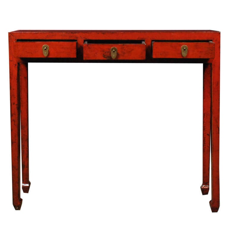 A red lacquer table from Northern China. This table features hoofed feet and three drawers with brass hardware.

Pagoda Red Collection # BJC071