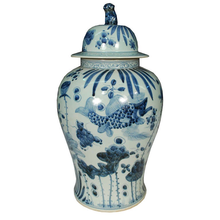 A delightful pair of blue and white covered jars. These jars are hand-painted with fish and sea foliage. A little Foo dog sits atop each lid.

      