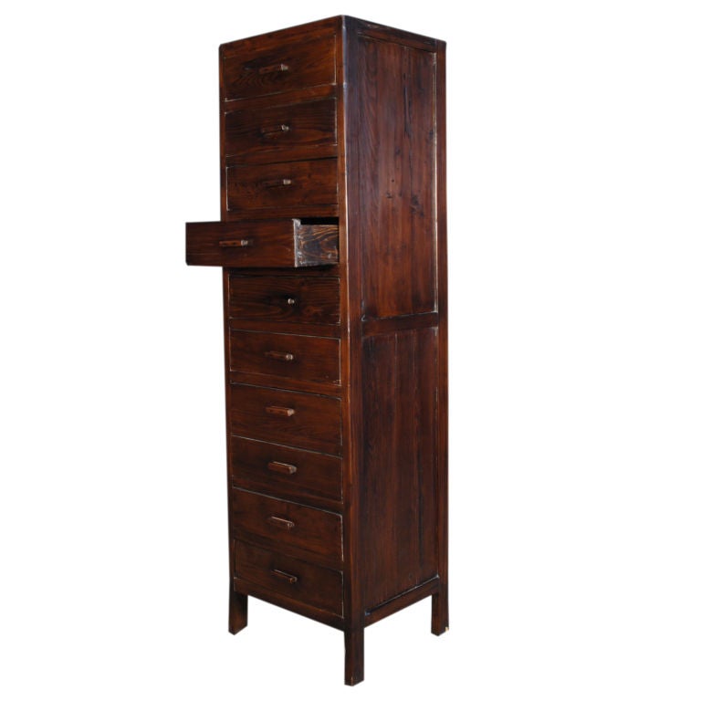 An early 20th century Chinese elmwood document cabinet with ten drawers.<br />
<br />
Pagoda Red Collection #:  ZZZ030<br />
<br />
<br />
Keywords:  Cabinet, chest, lingerie, file, apothecary, armoire, dresser, chest of drawers