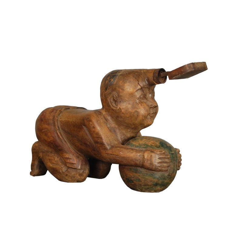 A 19th century Balinsian coconut husking stand carved in the form of a boy attendant.<br />
<br />
Pagoda Red Collection #:  HIC003<br />
<br />
<br />
Keywords:  Sculpture, Statue, Southeast Asian, China, Chinese
