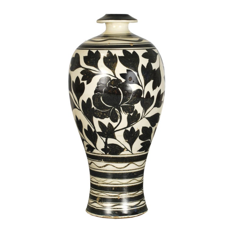 A 19th century Chinese black and white glazed porcelain meiping form vase, decorated with scrolling vines and a peony.<br />
<br />
Pagoda Red Collection #:  HIC004<br />
<br />
<br />
Keywords:  vase, vessel, urn, pot, basin, bowl, planter
