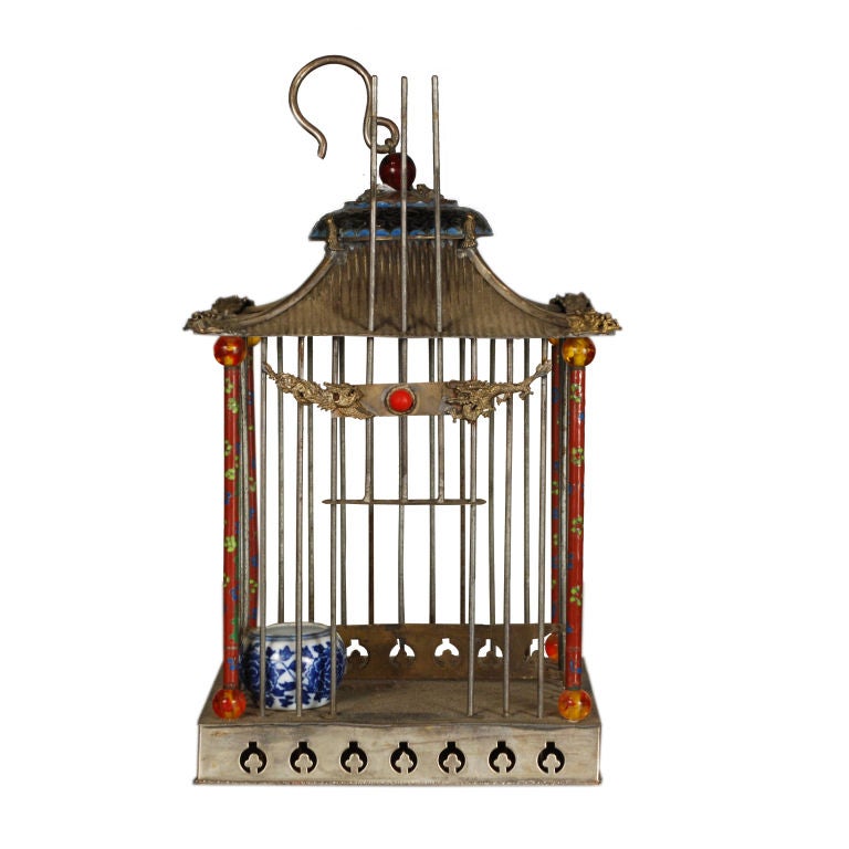 A 19th century Chinese silver and enamel birdcage decorated with dragons, including a blue and white bird feeder.<br />
<br />
Pagoda Red Collection #:  HIC006<br />
<br />
<br />
Keywords:  Bird cage, decorative, sculpture, statue