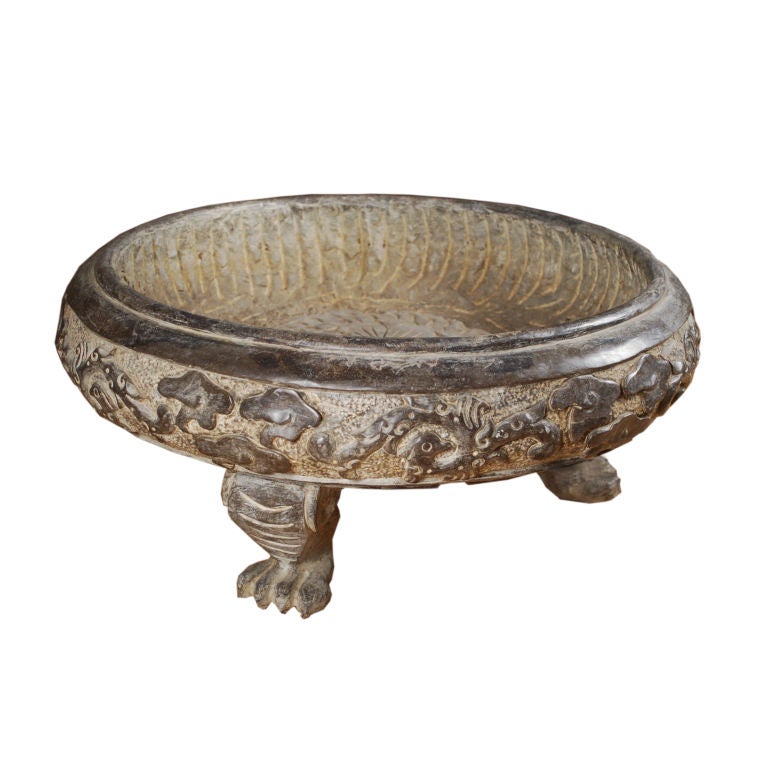 A shallow stone basin with carved clouds and phoenix, and three Fu dog feet.<br />
<br />
Pagoda Red Collection #:  W080<br />
<br />
<br />
Keywords:  Basin, planter, bowl, urn, vase, vessel, pond