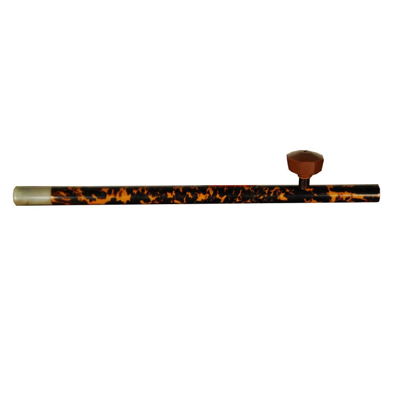 An early 20th century Chinese tortoise shell opium pipe with jade mouthpiece and Yixing pottery bowl, mounted on custom steel stand.<br />
<br />
Pagoda Red Collection #:  HIA001<br />
<br />
<br />
Keywords:  Pipe, scholars', China, Chinese,