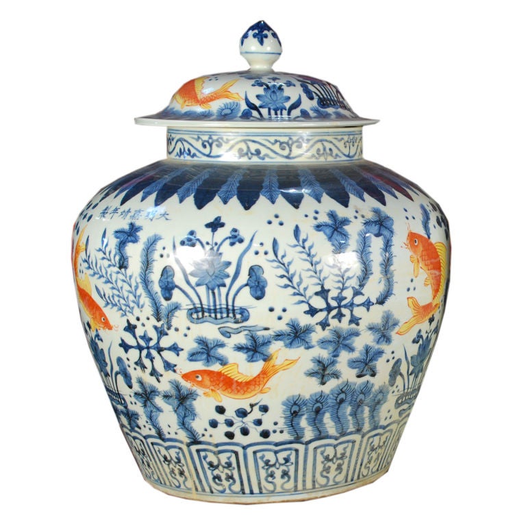 A pair of 20th Century Chinese blue and white glazed porcelain jars depicting aquatic plants and orange glazed carp.<br />
<br />
Pagoda Red Collection #:  ZZZ079<br />
<br />
<br />
Keywords:  Jar, vase, urn, bowl, vessel, basin, planter,