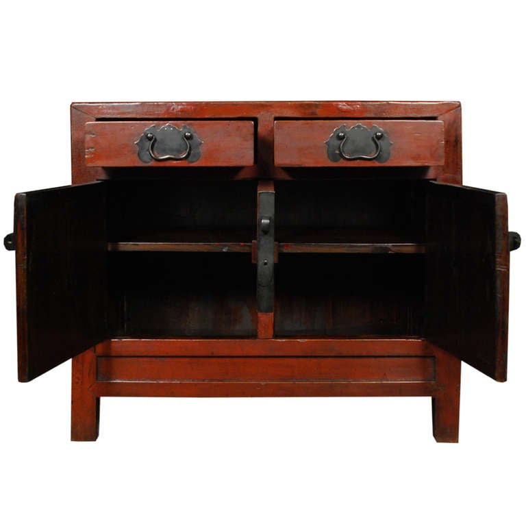 A lovely dark red chest with two drawers and two doors. The large black hardware makes a bold statement against the red and the drawer handles are shaped like bats. Bats are a symbol of blessings and longevity..

Pagoda Red Collection # BJB075