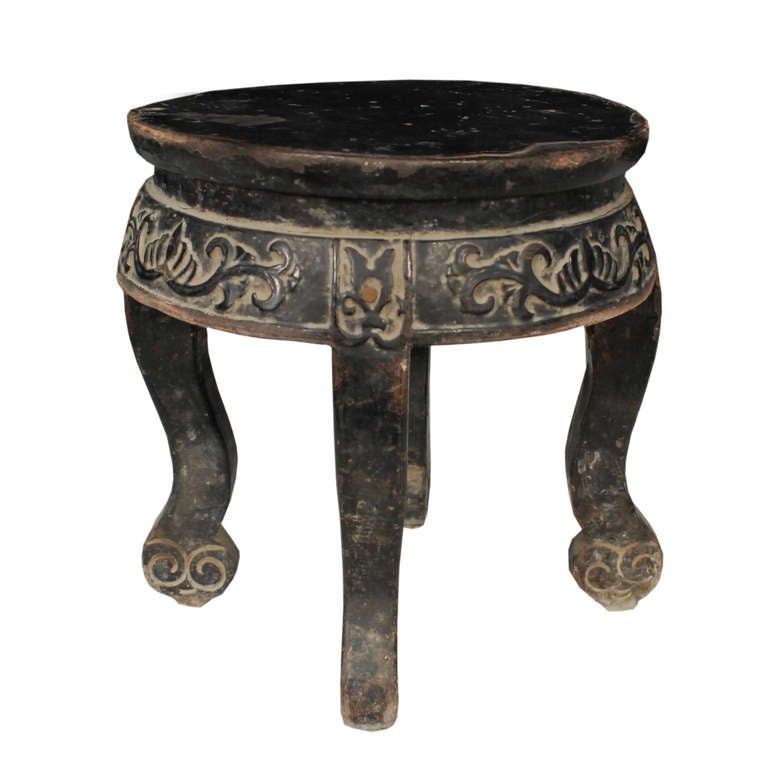 A small round display table from from Northern China. This table is made of Chinese Northern Elm and has been carved and lacquered.