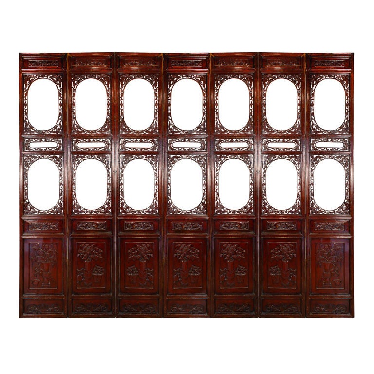 A set of seven 19th century Chinese courtyard lattice panels each depicting an auspicious potted flowering plant. These panels are each backed with mirror.