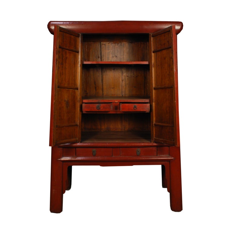 An early 20th century Chinese red lacquered elmwood cabinet with exaggerated proportions and wonderful butterfly hardware with hand colored glass insets.<br />
<br />
Pagoda Red Collection #:  Z180<br />
<br />
<br />
Keywords:  Cabinet,