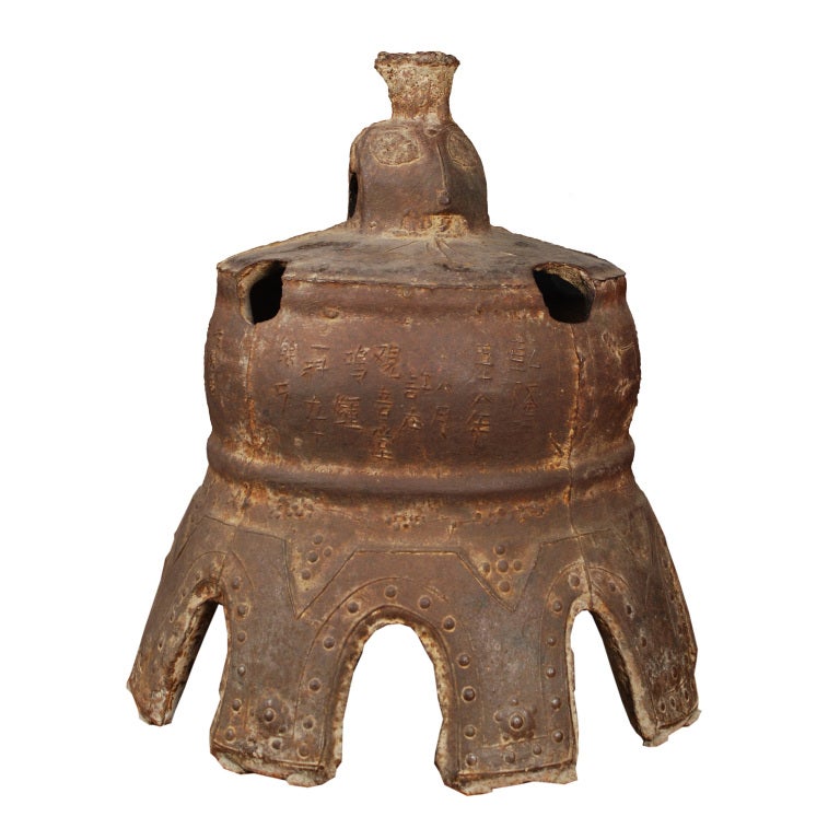 This lovely Qing-dynasty bell once pealed in a Chinese village, sounding out in celebration or giving notice of important events. Expertly forged, the cast-iron bell is detailed with characters in intricate relief, and its exaggerated scallop rim is