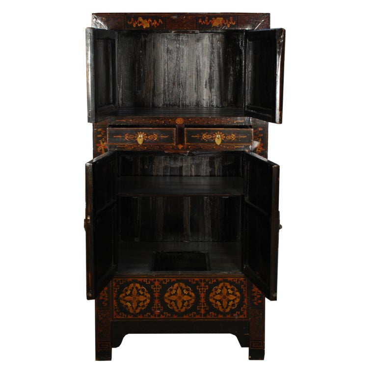 A 19th century Chinese elmwood cabinet painted with the 