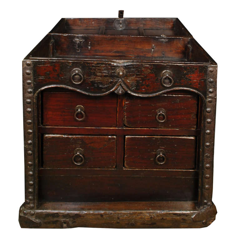 A low iron clad chest with four drawers. The top also opens like a trunk for additional storage. This c. 1800 chest is from Shanxi Province and is made of Elmwood and iron.

Pagoda Red Collection # BJC080