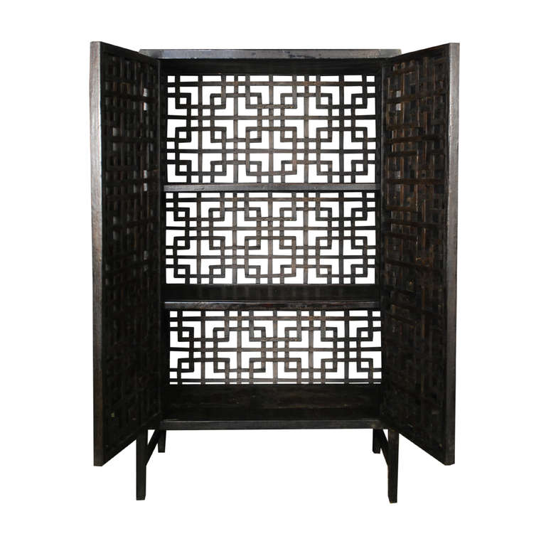 An incredible four sided lattice collector's cabinet. This cabinet has brass hardware and two shelves. This type of cabinet is also referred to as a cat box. They were used in China to store food and precious belongings and allow moisture to escape