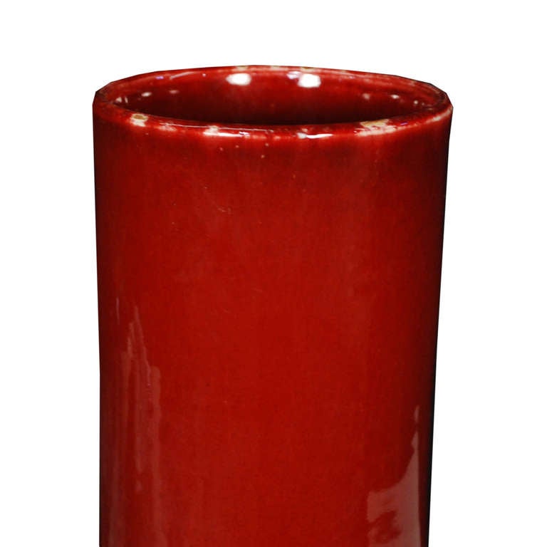 A grand bottleneck vase from Southern China. This deep red vase is made of ceramic and stands 20.5