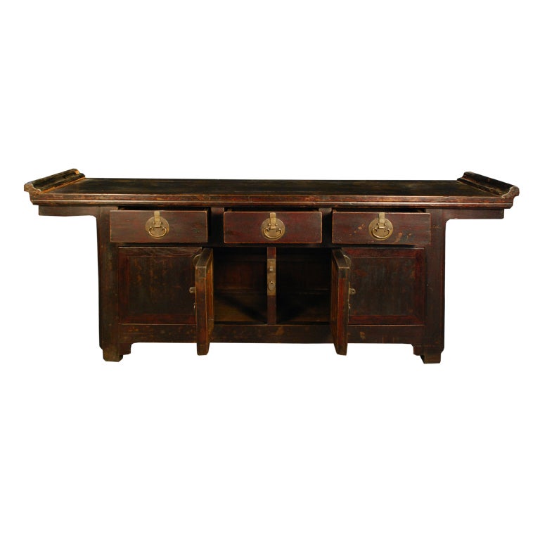 A 19th century Chinese elmwood altar coffer with three drawers and two doors with brass hardware.