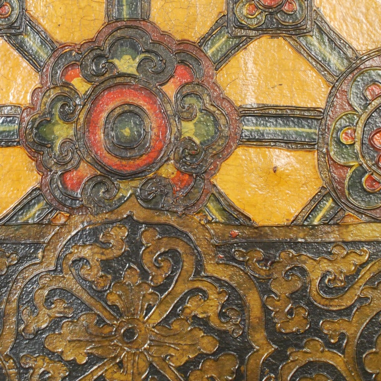 A 19th century painted door panel from Tibet with a floral lattice pattern on a goldenrod background.