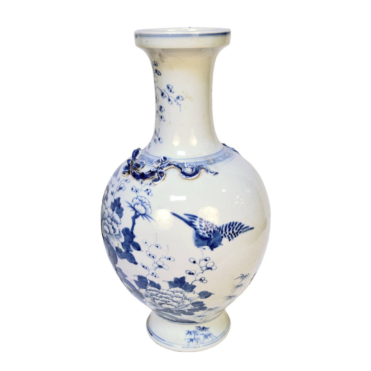 A blue and white porcelain vase from Beijing, China was a songbird motif and raised reptile along the neck.