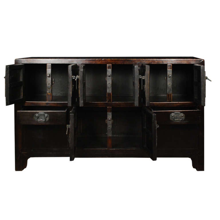 A c. 1850 coffer from Shanxi Province, China. This coffer has eight doors and two drawers. The top six drawers all open to a large shared storage space. This coffer is made of Chinese Northern Elmwood.

Pagoda Red Collection # BJB072