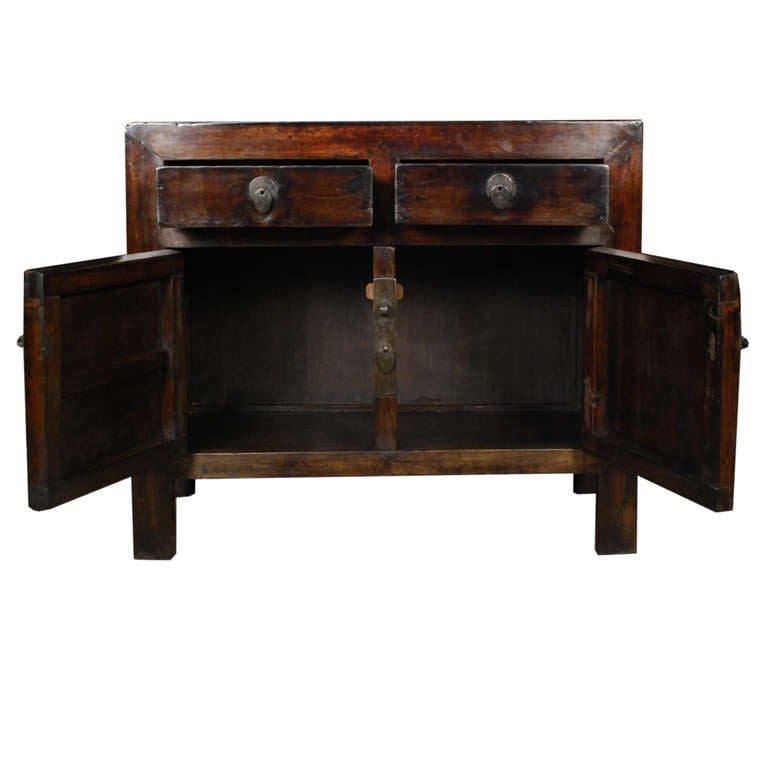 A lovely c. 1850 chest from Beijing, China. This chest is made of Camphor and features two drawers and two doors, all with brass hardware.

Pagoda Red Collection # BJC117