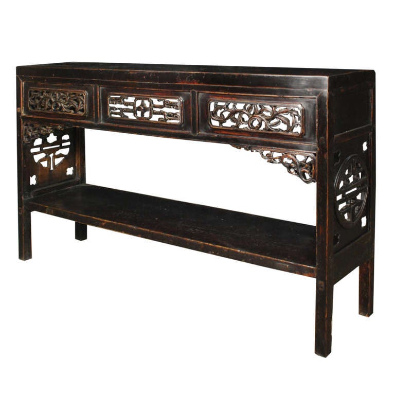 A 19th century Chinese elmwood altar table with scrolling vine carved apron and a shelf.

Pagoda Red Collection #:  BJB090

Keywords:  Table, console, sideboard, buffet, server, credenza, sofa table, entry