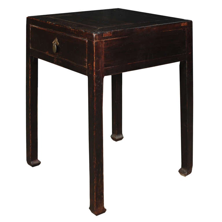 A tall table from Shanxi Province, China. This table is made of Chinese Northern Elmwood and features one drawer with brass hardware.