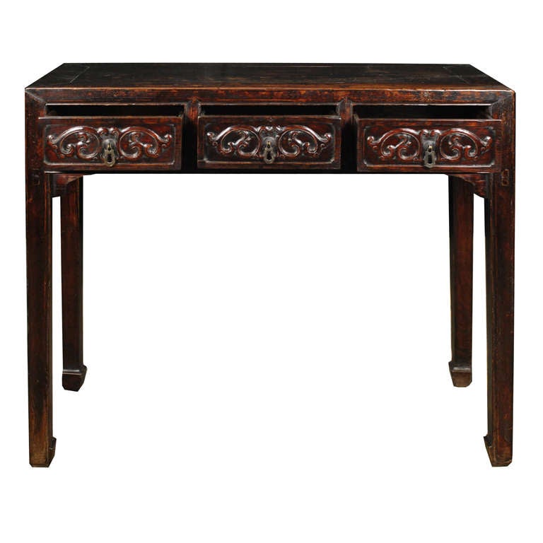 A 19th century Chinese elmwood altar table with three drawers, each carved with scrolling vines with brass hardware, and legs ending in hoof feet.

Pagoda Red Collection #:  BJB036

Keywords:  Table, console, sofa table, sideboard, buffet,