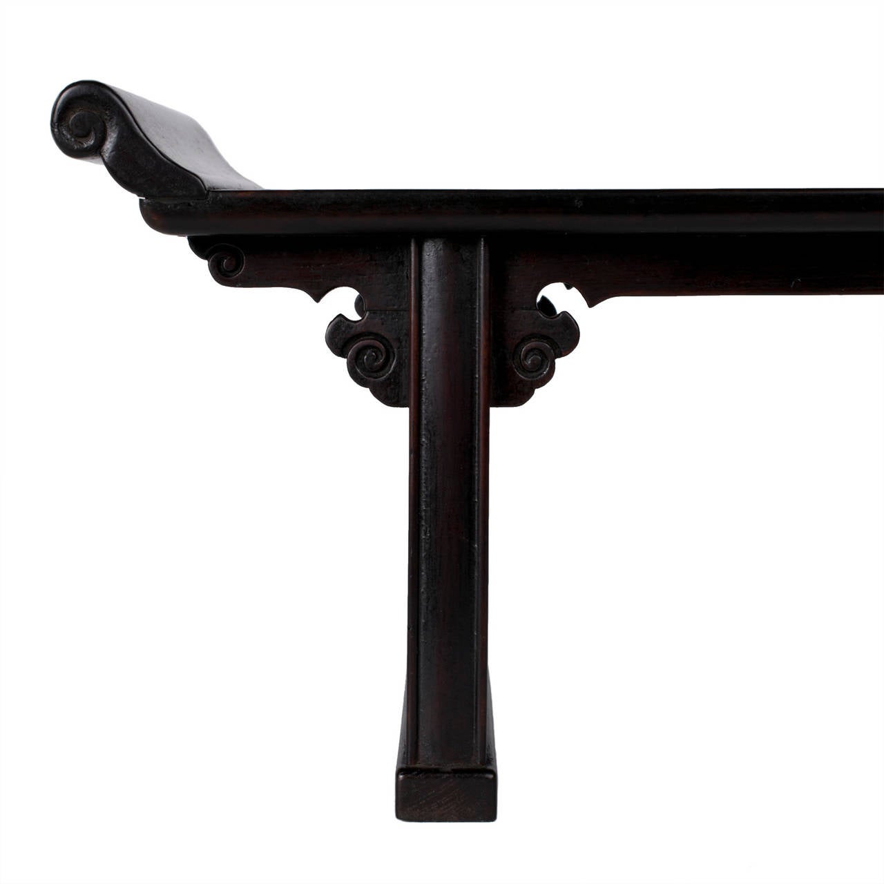 Miniature poplar black altar table with everted ends, cloud scroll spandrels and carved side panel.