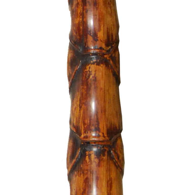 A bamboo smoking pipe on a custom metal stand. This species of bamboo is known as Buddha belly and was purposefully deprived of water during growth to cause the bulbous 'belly' form.

     
