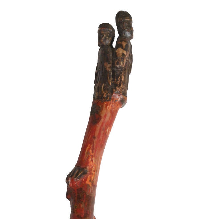 Beautifully hand carved Chinese Folk Art walking stick. The exotic root wood cane features small carved animals and two figures atop of the cane.