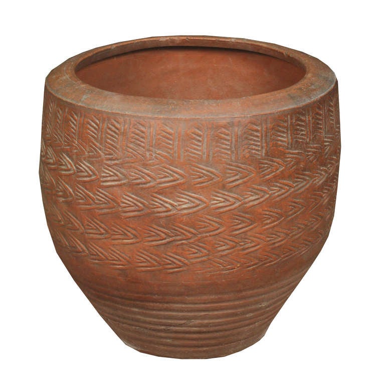 An early 20th century Chinese stamped clay pickling pot with all-over stylized blowing wind pattern.