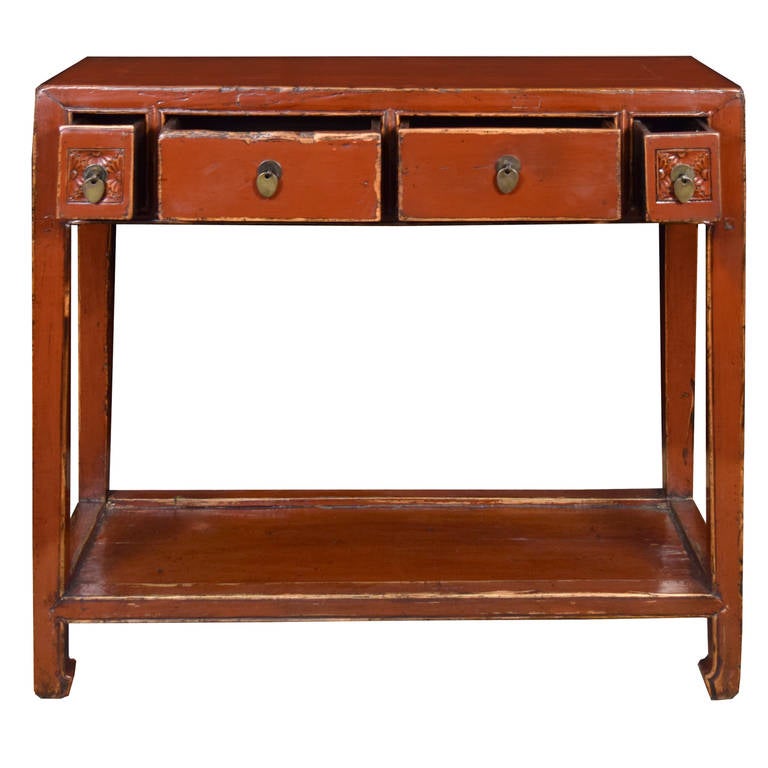 A sweet red lacquer altar table from Northern China. This circa 1900 table features a low shelf and is made of Chinese Northern Elmwood. There are two large drawers flanked by two smaller carved drawers for lots of storage.

Pagoda Red Collection