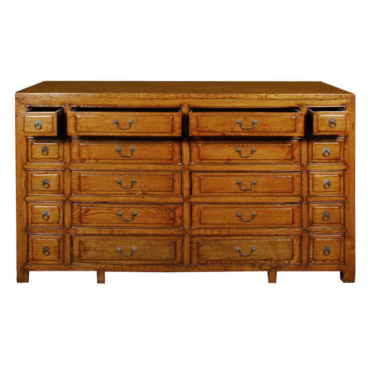 A circa 1850 elmwood apothecary chest from China with twenty drawers, each with brass hardware. 

Pagoda Red Collection # NSX001

Keywords: Chest, dresser, sideboard, server, credenza, console table