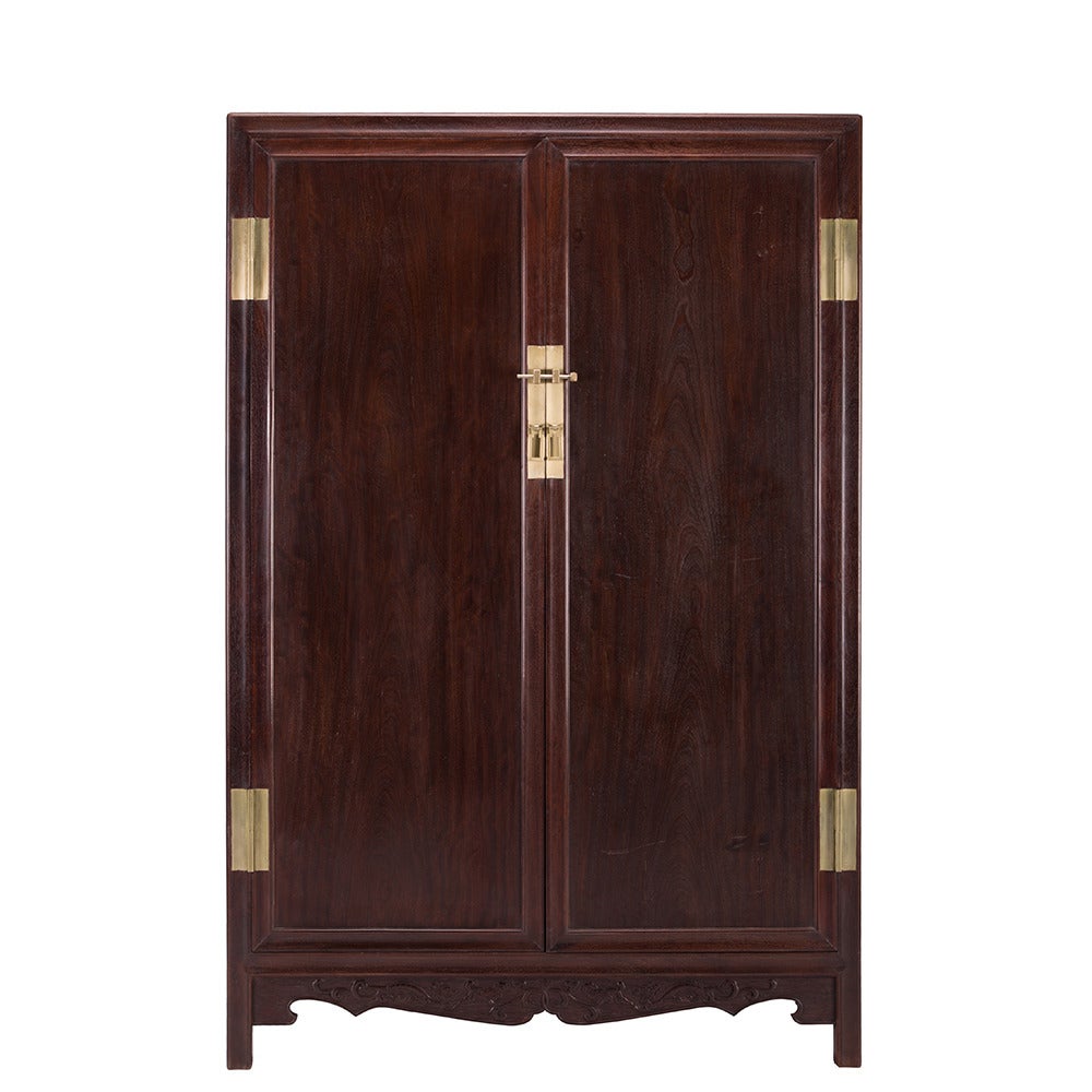 A pair of Chinese Ironwood book cabinets with brass hardware and two doors and three drawers each. The doors are each a solid plank of wood and the backs of each cabinet can be removed. 

Pagoda Red Collection # PD74155112