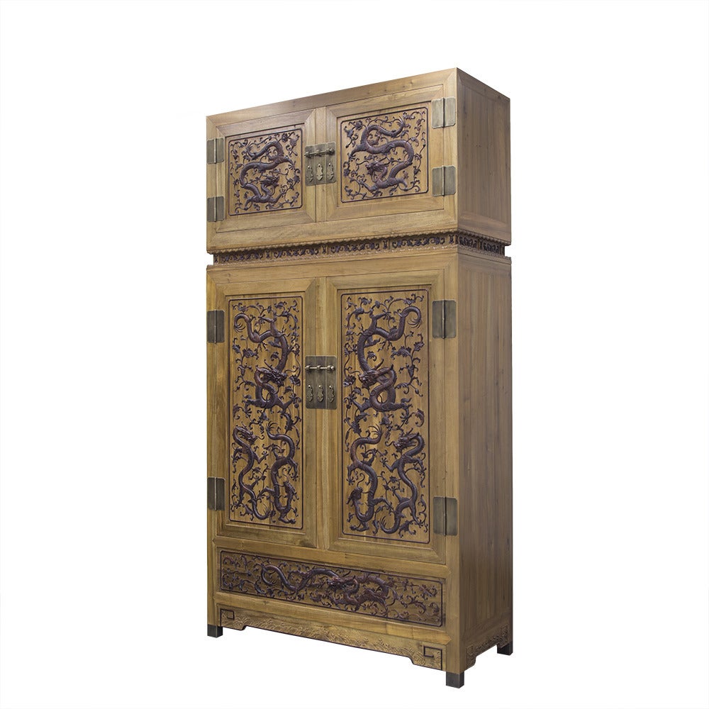 An impressive pair of cedar compound cabinets from China with zitan dragon inlay. Each cabinet features four doors and shelves within. A floral and vine inlay separates the top and bottom sections of each compound cabinet.