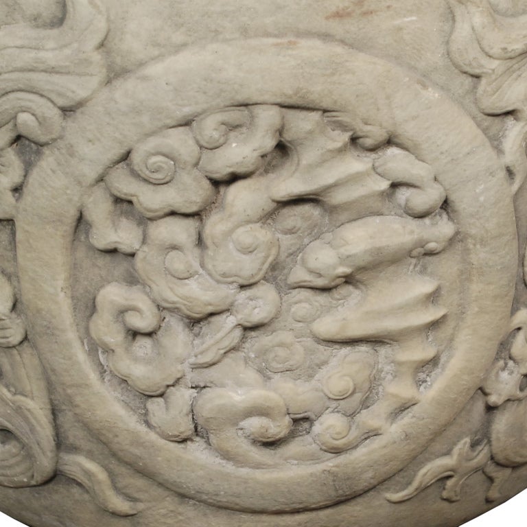 A 19th century carved stone basin depicting swirling Imperial dragons surrounding multiple auspicious animals including Fu dogs, deer, bats, and magpies.

Pagoda Red Collection #:  BJAA066

Keywords:  Basin, planter, pot, urn, jardiniere,