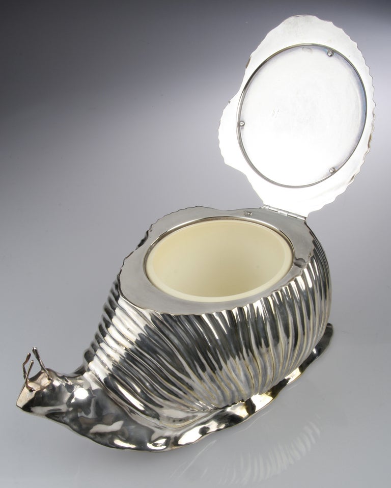 This is a  whimsical silver plated Ice bucket from Teghini of Florence, Italy. The well crafted form has a lid that opens to reveal an inner removable lining.