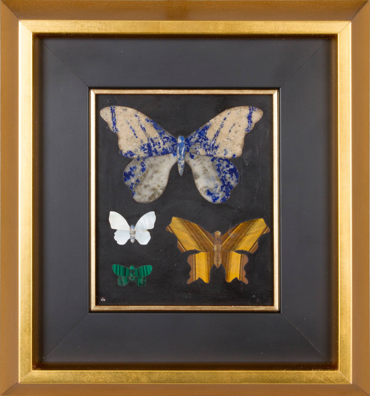 This is a modernist Pietra Dura, by Blow, who revitalized the art of inlaid stone. This piece has malachite, tigers eye, mother of pearl and lapis all artfully inlaid in a black marble. It is framed in a modern gold leaf frame.