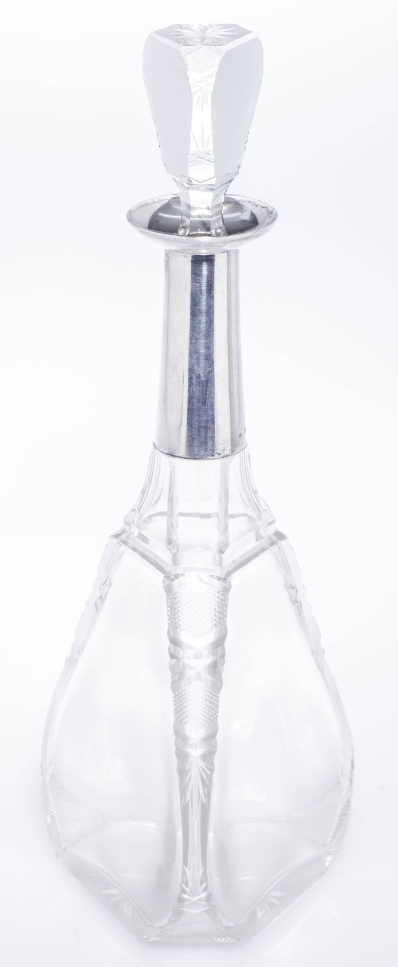 These are a beautiful and unusually shaped triangular cut crystal decanters accented with 800 Continental silver.