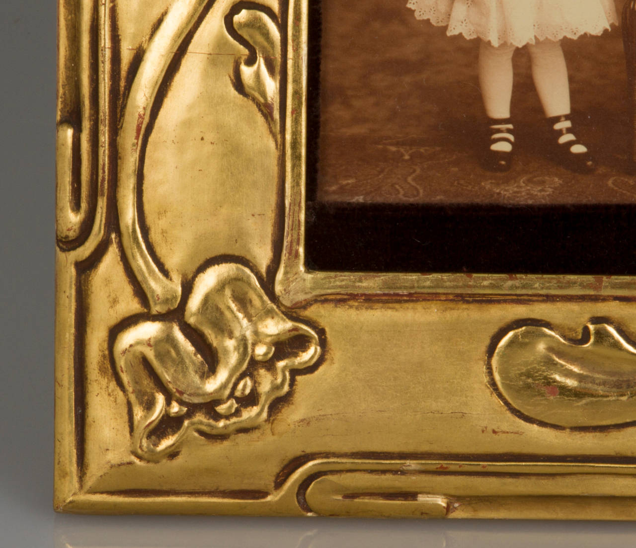 This is a beautifully carved frame. The photos are held in place by a brown velvet liner. These are the original photos that came with the frame. There is a Carson Pirie Scott & Company label on the back, a premier department store in its day.